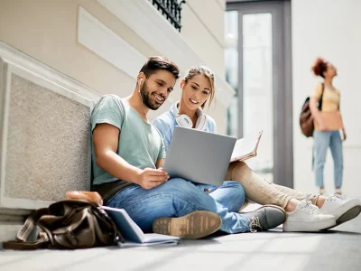 happy-university-friends-using-laptop-while-studyi-2022-11-09-03-50-42-utc